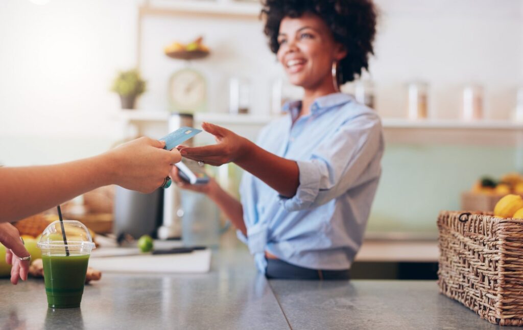 Female employee taking payment from customer