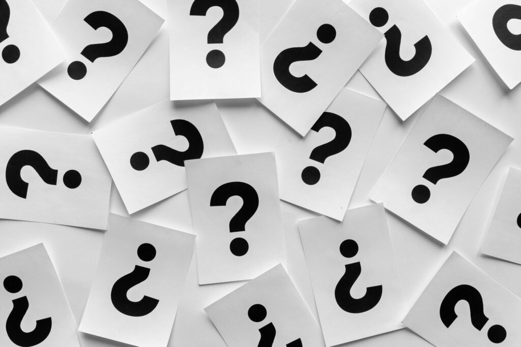 Bold black question marks on paper cards