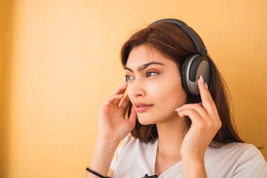 Young woman listening music with headphones.