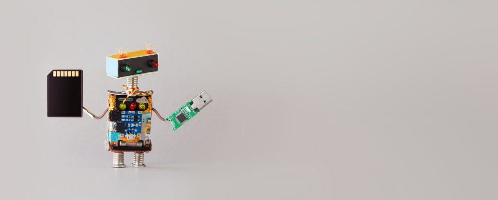 Robot with storage electronic equipment accessories usb and memory card. copy space for text.