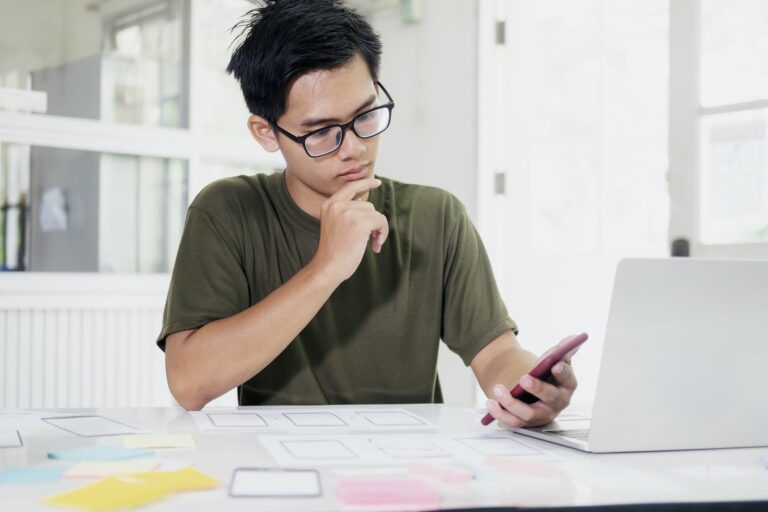 Web designer, UX UI designer designing mobile application user interface.