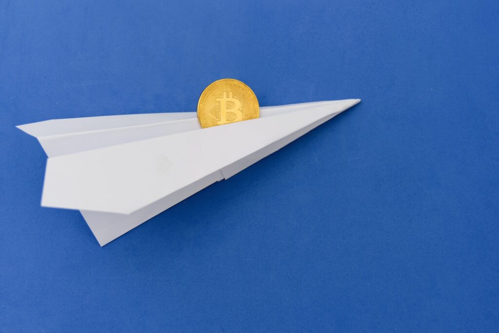 Bitcoin flying on paper plane