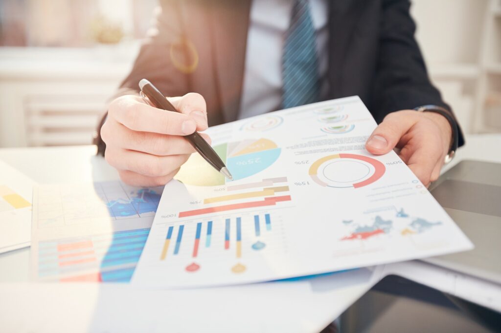 Businessman Pointing at Statistics Data Close up