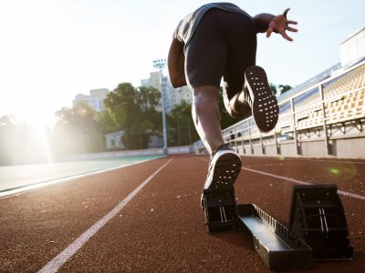 back-view-of-a-young-male-athlete-launching-off-the-start-line