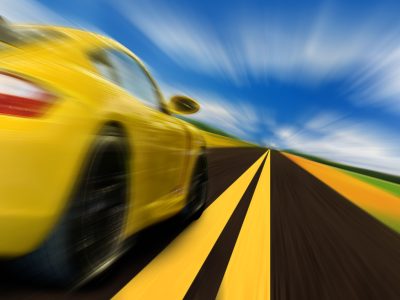 High-speed motion-blurred auto on rural highway