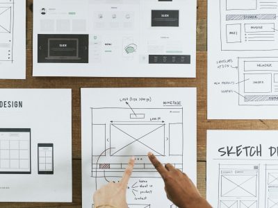 Hands point to web design document