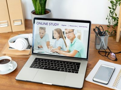 Homepage of educational website on laptop display on workplace