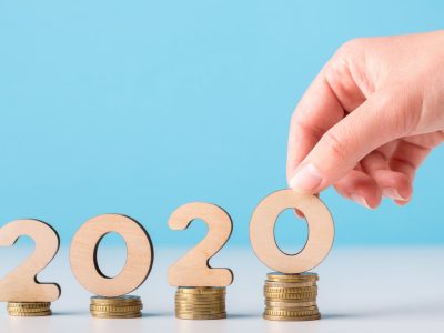 man-hand-with-2020-concept-on-coins-ascending
