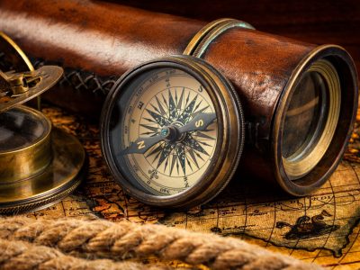 old-vintage-compass-and-navigation-instruments-on-ancient-map