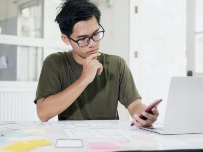 Web designer, UX UI designer designing mobile application user interface.